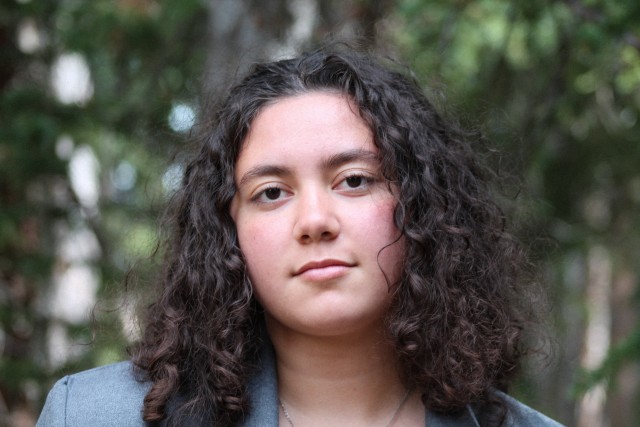 Young woman in nature smiling at the camera