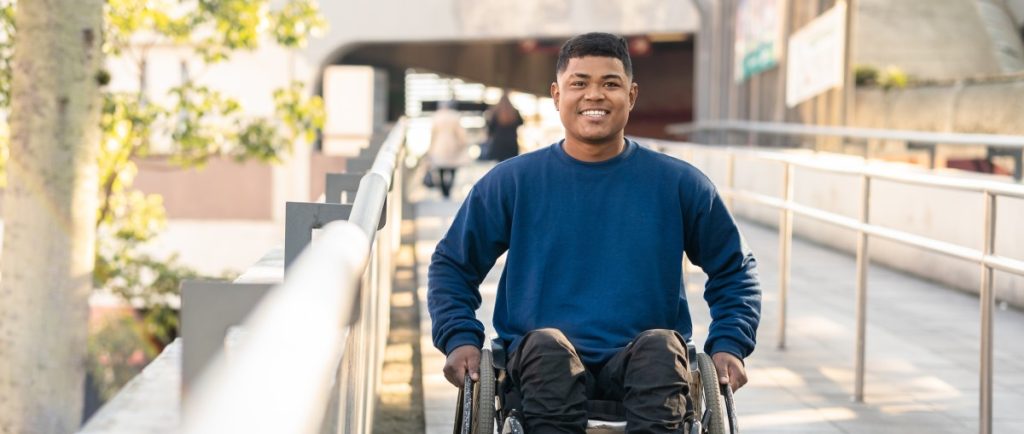 Disabled man in wheelchair smiling at the camera