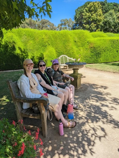 Founder with family and friends sitting on park bench